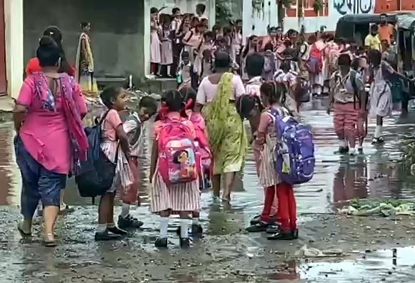 In Bharuch, children are forced to wade through dirty water to go to school due to the system